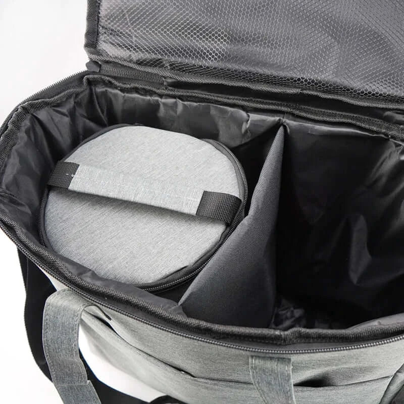 interior view of waterproof pet travel bag with spacious compartments and a round storage container inside