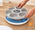Load image into Gallery viewer, User assembling WiFi Smart Pet Feeder with portion control for wet and dry food options on a wooden surface.
